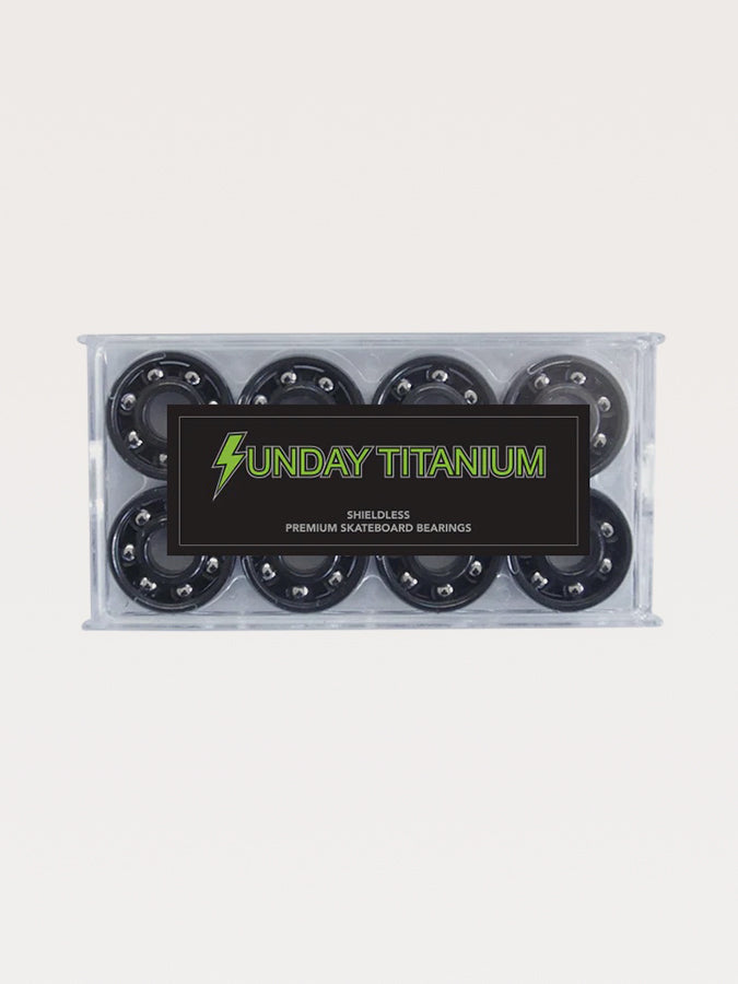 Set of premium skateboard bearings branded ’Sunday Titanium’ in a clear plastic case.