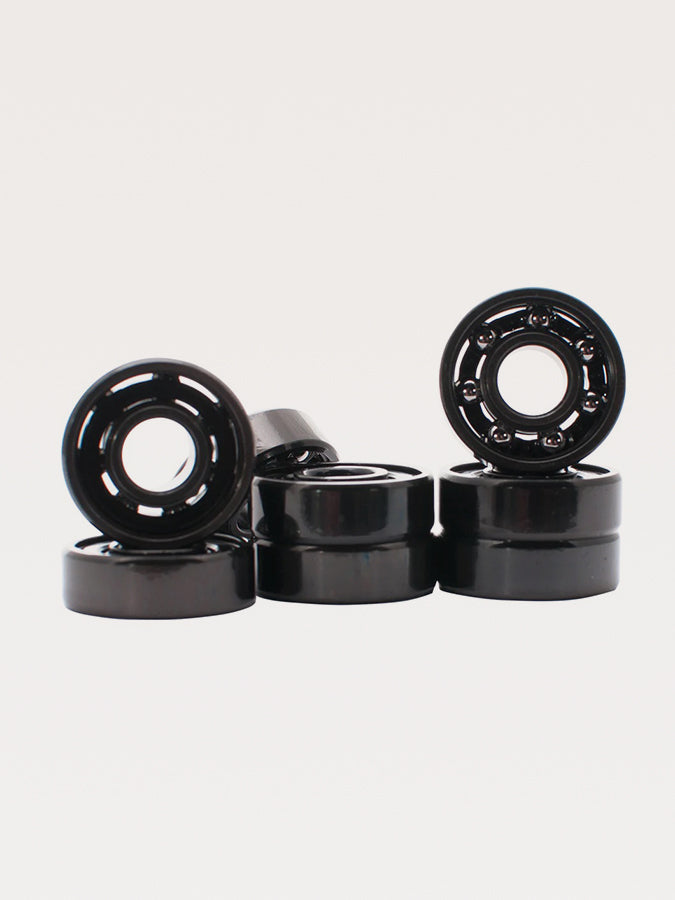 Black skateboard or roller skate bearings arranged in a group.