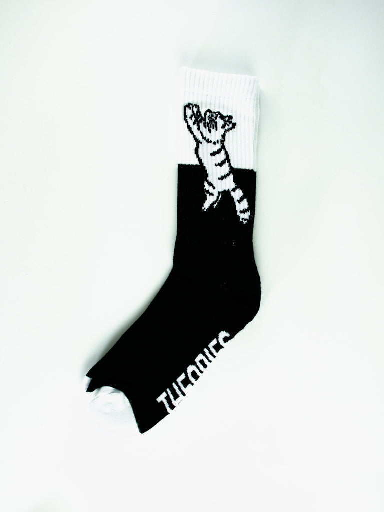 Black sock with a white tiger tail design.