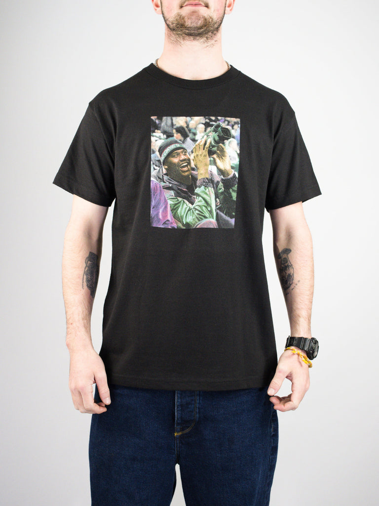 Black t-shirt with a colorful photographic print on the front.