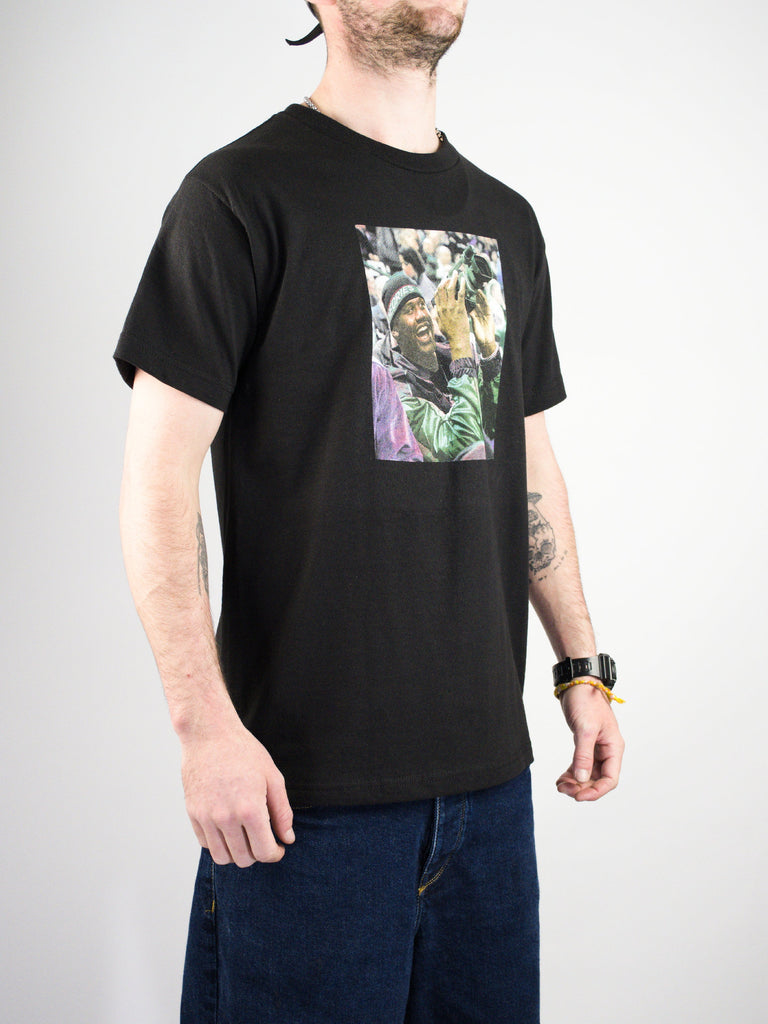 Black t-shirt with a colorful graphic print on the front.