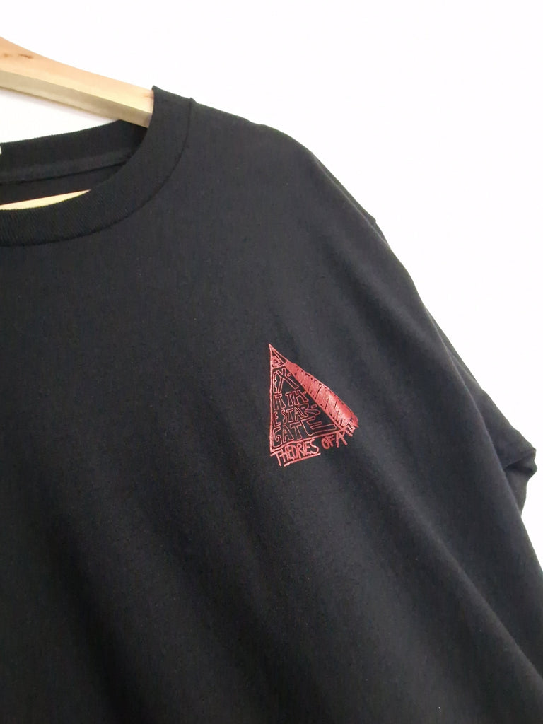 Black t-shirt with a small red triangular logo.