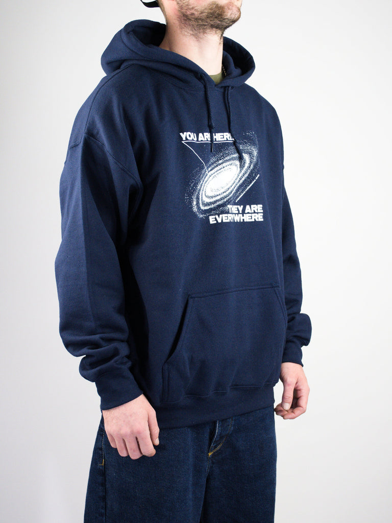 Navy blue hoodie with a spiral galaxy graphic and text design on the front.