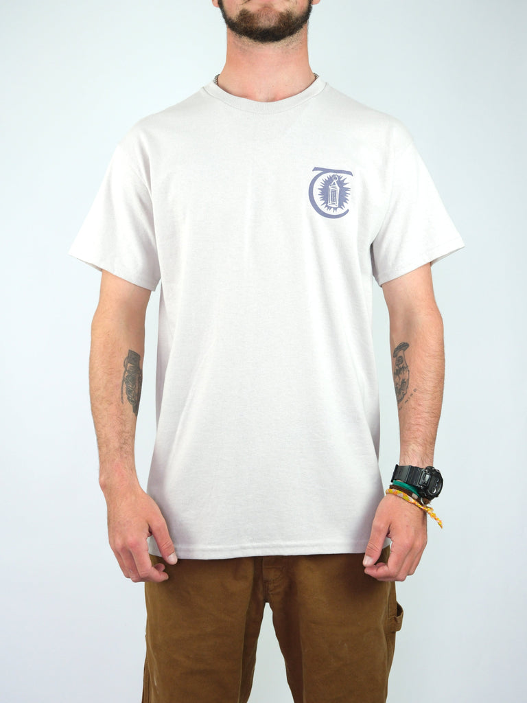 White t-shirt with a small circular logo on the chest.