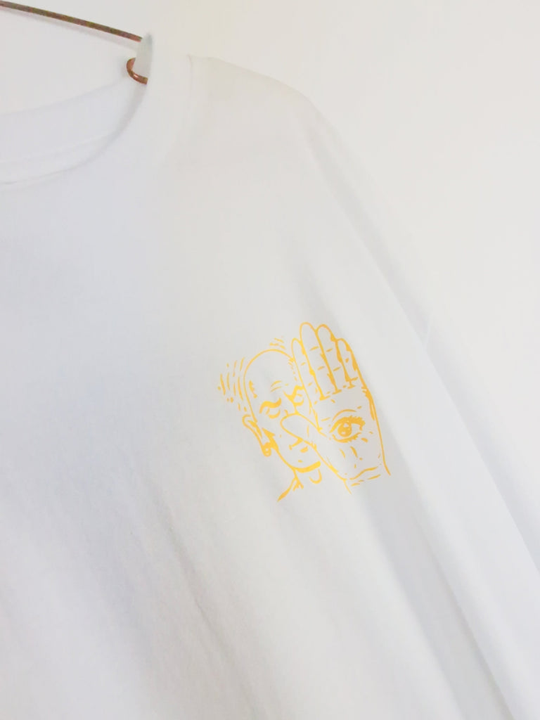 Golden embroidered or printed profile silhouette on white fabric.
