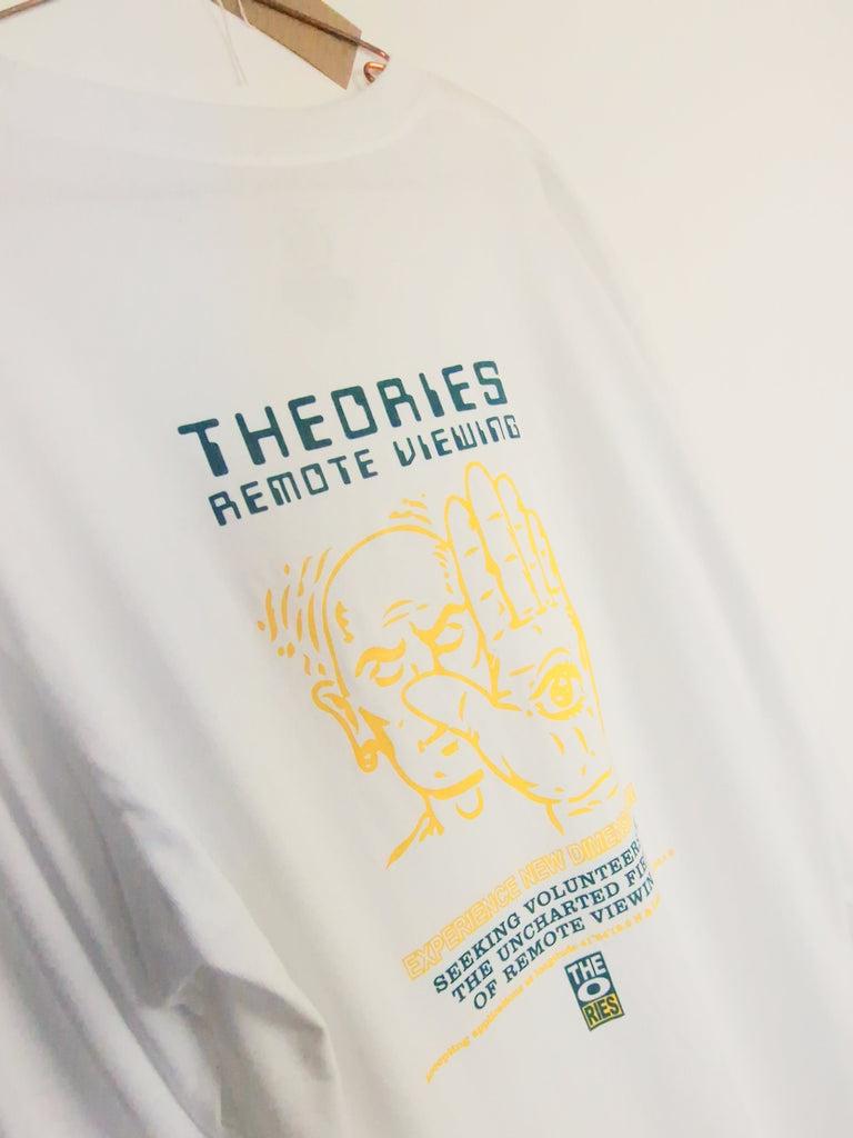 White t-shirt with ’THEORIES’ text and yellow graphic design printed on it.