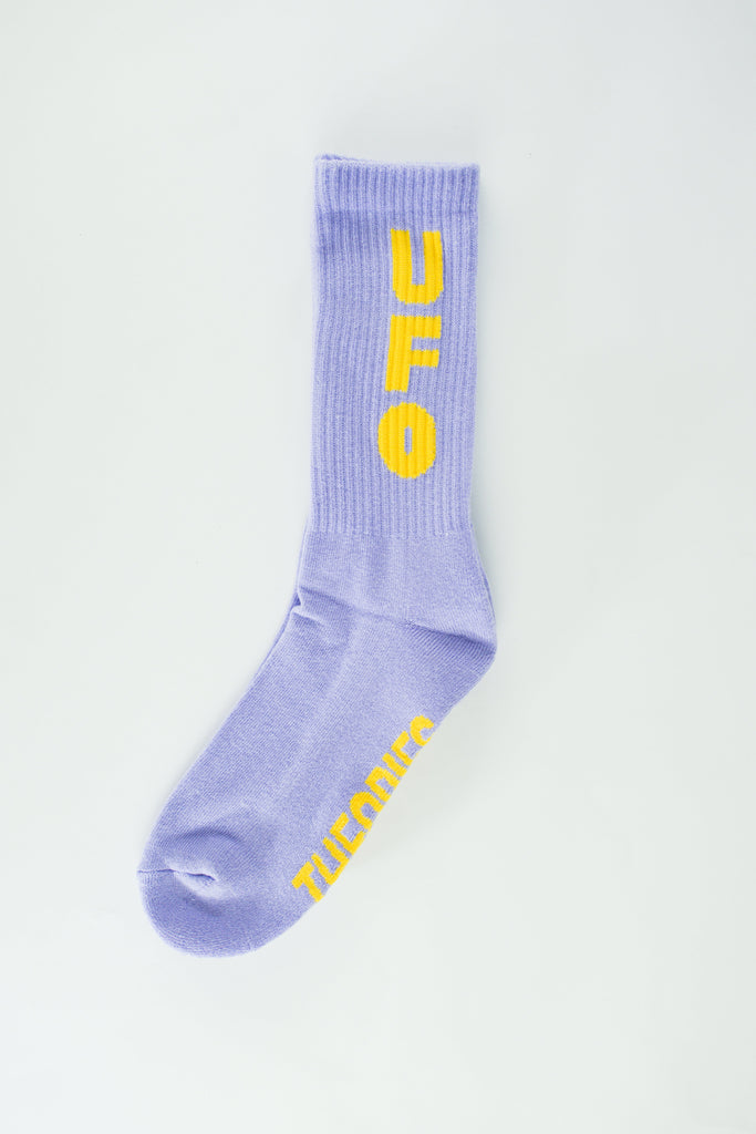 Lavender athletic sock with yellow ’UFO’ text printed vertically along the side.