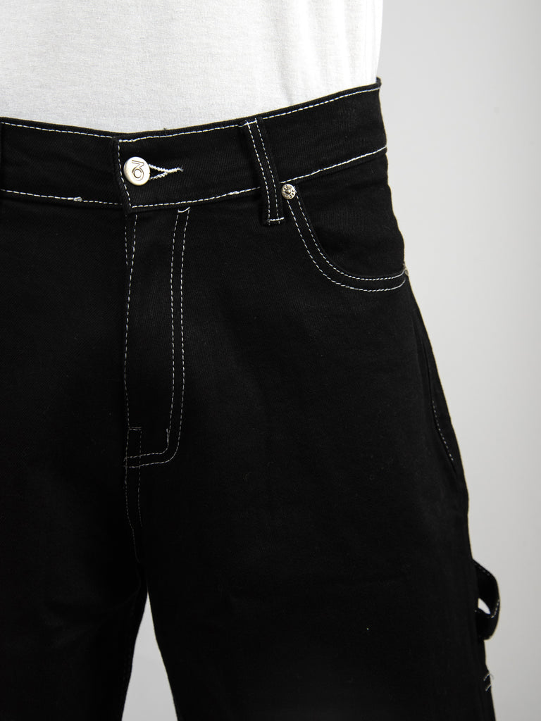 Black denim jeans with contrasting white stitching and a button closure.