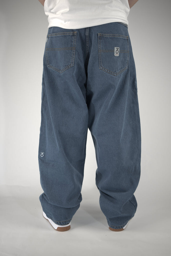 Baggy blue jeans with logo on pocket from Three Sixty Clothing, Mid Wash Blue style