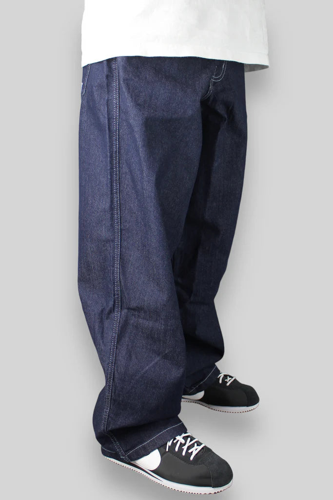 Navy blue baggy jeans with visible stitching and a sneaker at the bottom.