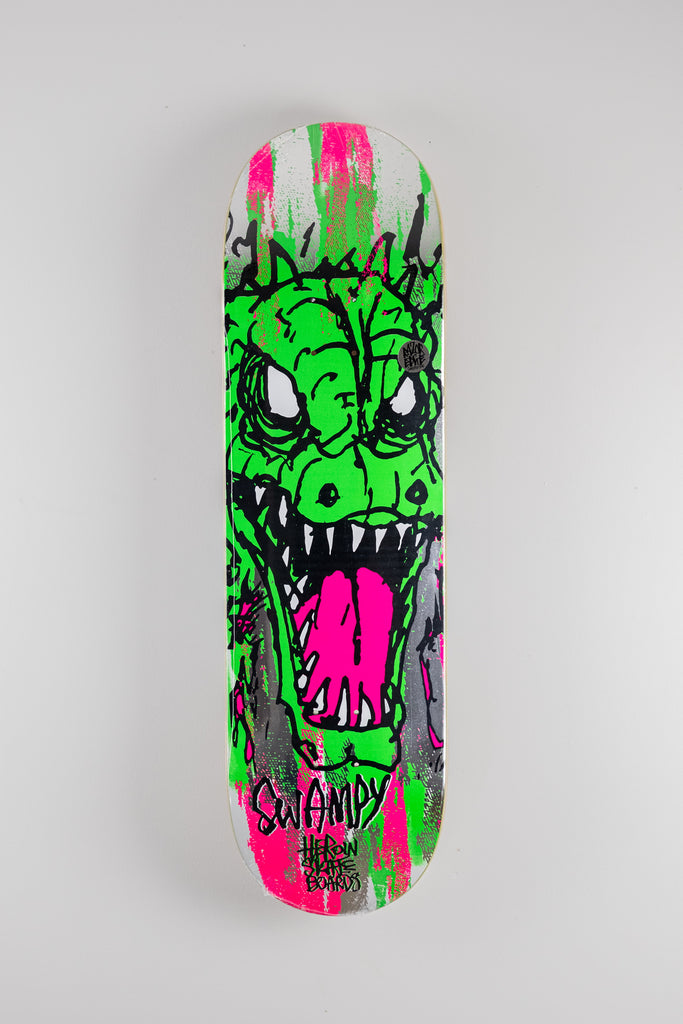 Skateboard deck with vibrant green monster design from Heroin Skateboards Savages Series