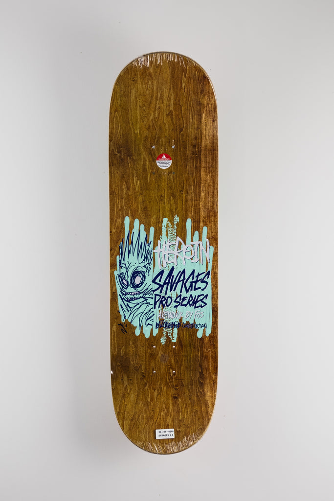 Wooden skateboard deck featuring blue graffiti text from Heroin Skateboards Savages Series