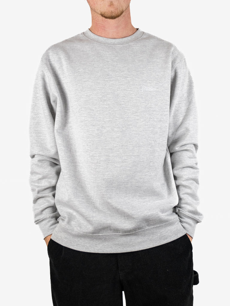 Light gray crewneck sweatshirt worn by a person from Studio Skateboards Small Script collection