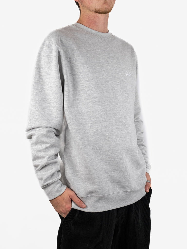 Light gray crewneck sweatshirt displaying Studio Skateboards Small Script design