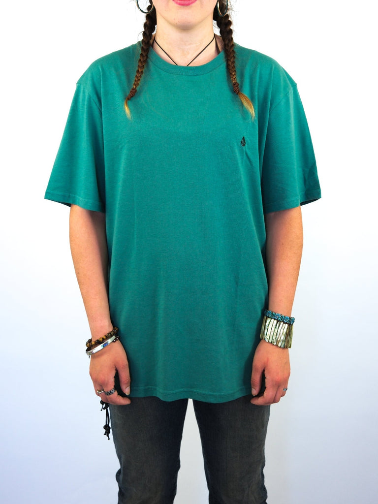 Teal green t-shirt with a small embroidered logo.