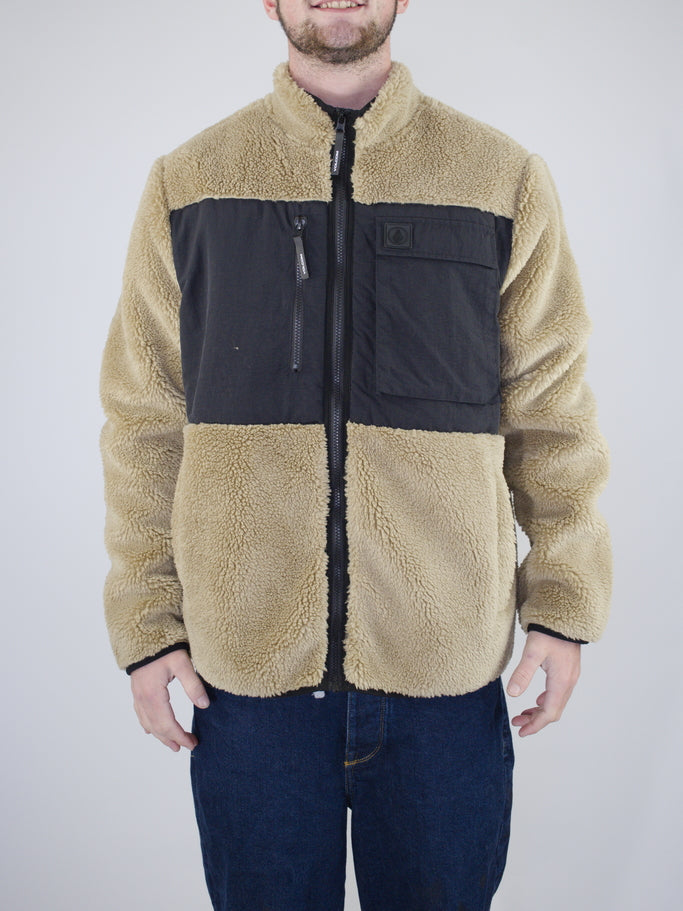 Beige and black fleece jacket with a chest pocket and full zipper.