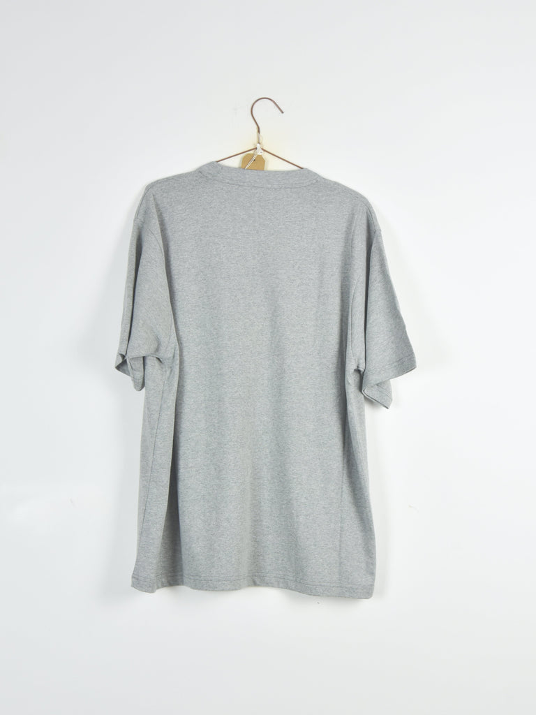 Plain gray t-shirt hanging on a wooden hanger.