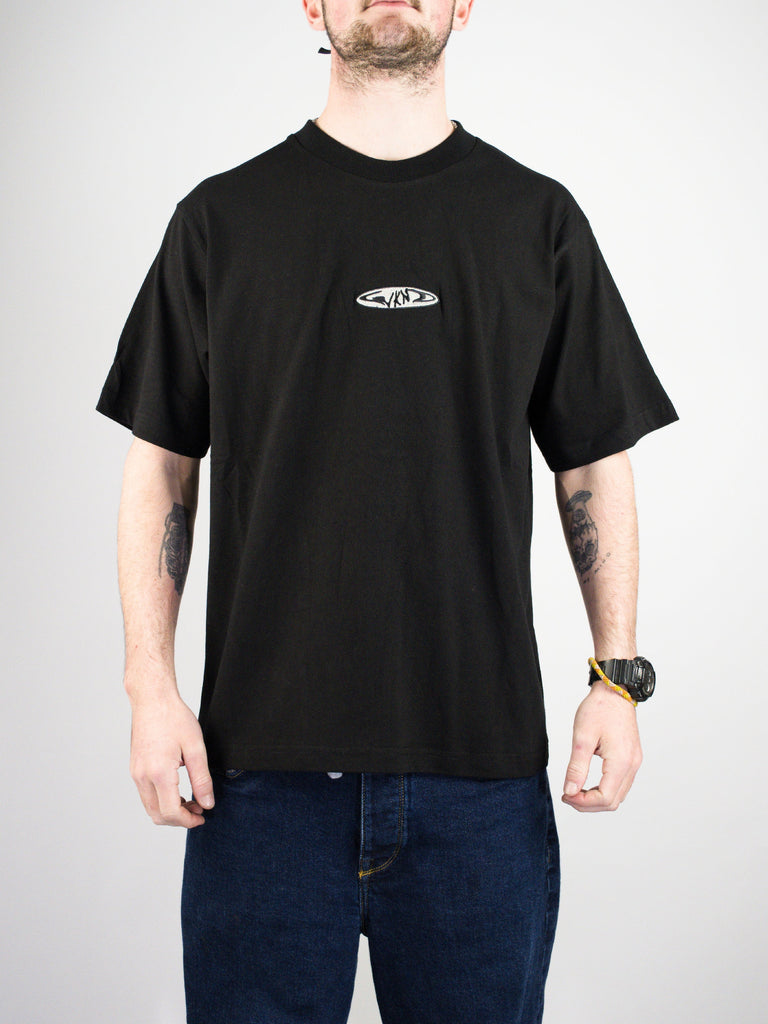 Black t-shirt with a small oval logo on the chest.