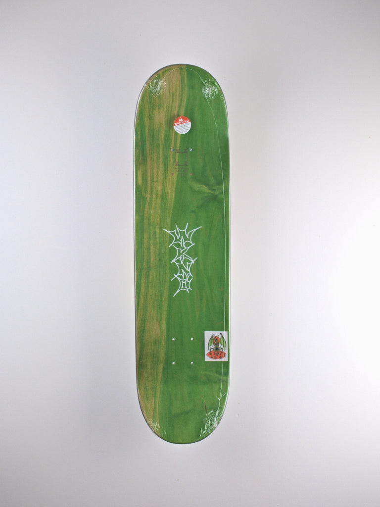 Green skateboard deck with white graphic designs and a small sticker.