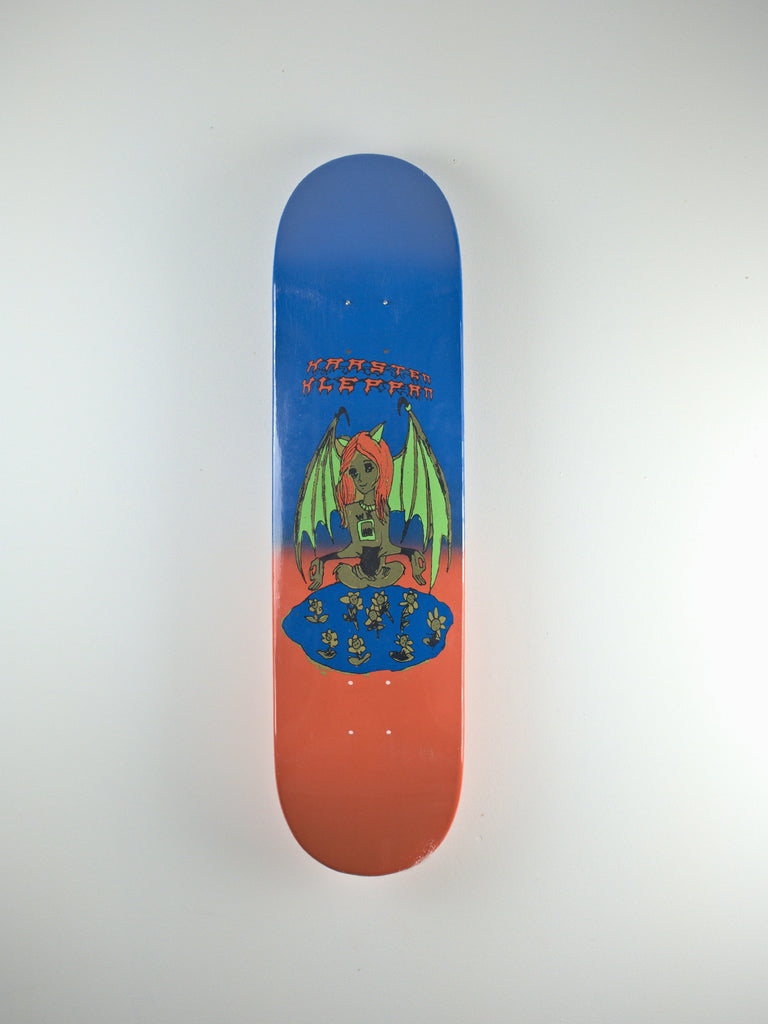 Skateboard deck featuring a colorful dragon design and ’MUSCLE SLEEPER’ text.
