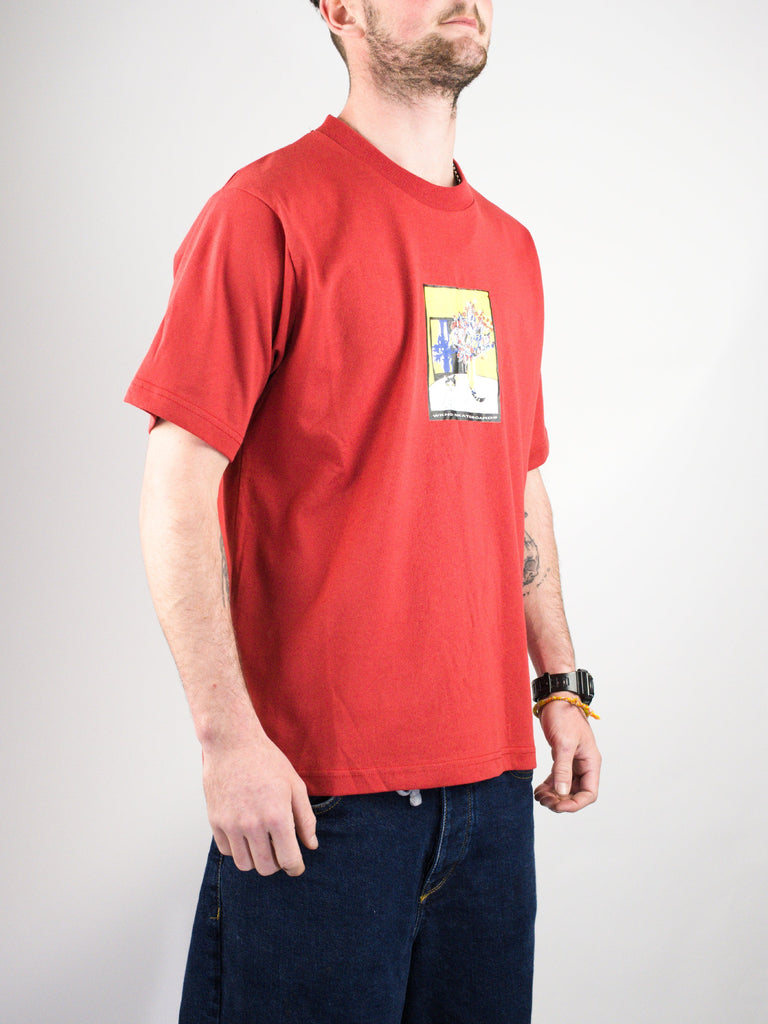 Red t-shirt with a rectangular graphic print on the front.