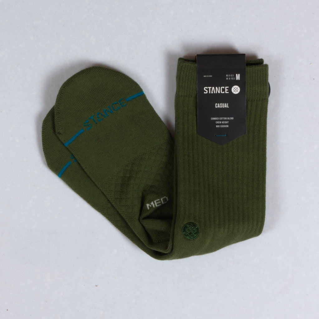 Pair of olive green ribbed socks with packaging.