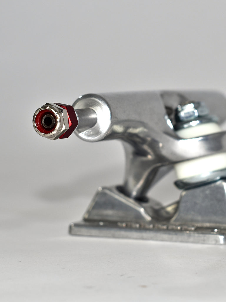 Skateboard truck with a visible axle nut and mounting hardware.