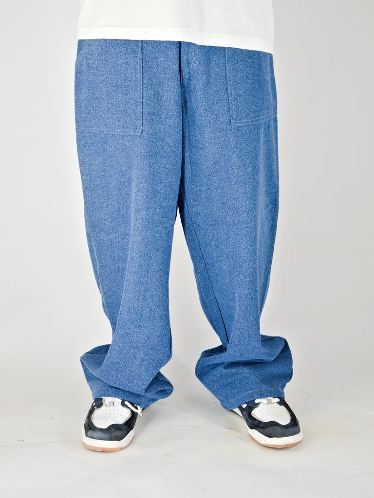 Baggy blue jeans with wide legs and visible creases.